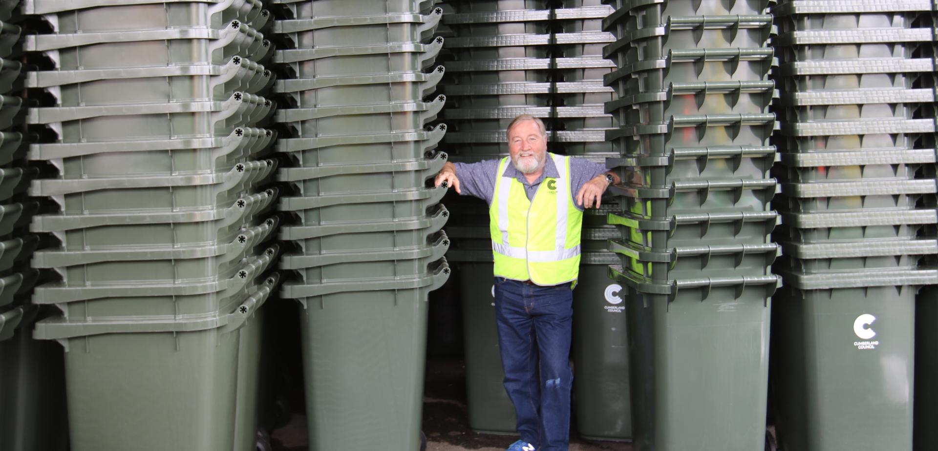garden bins mayor Mayor Cummings standing in front of stacked garden bins