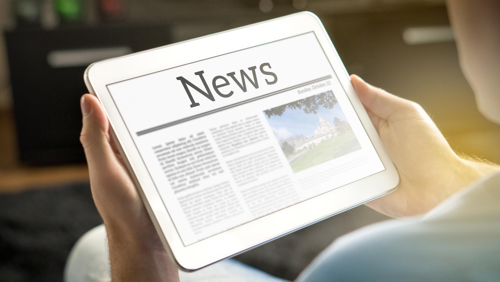 man reading news on tablet